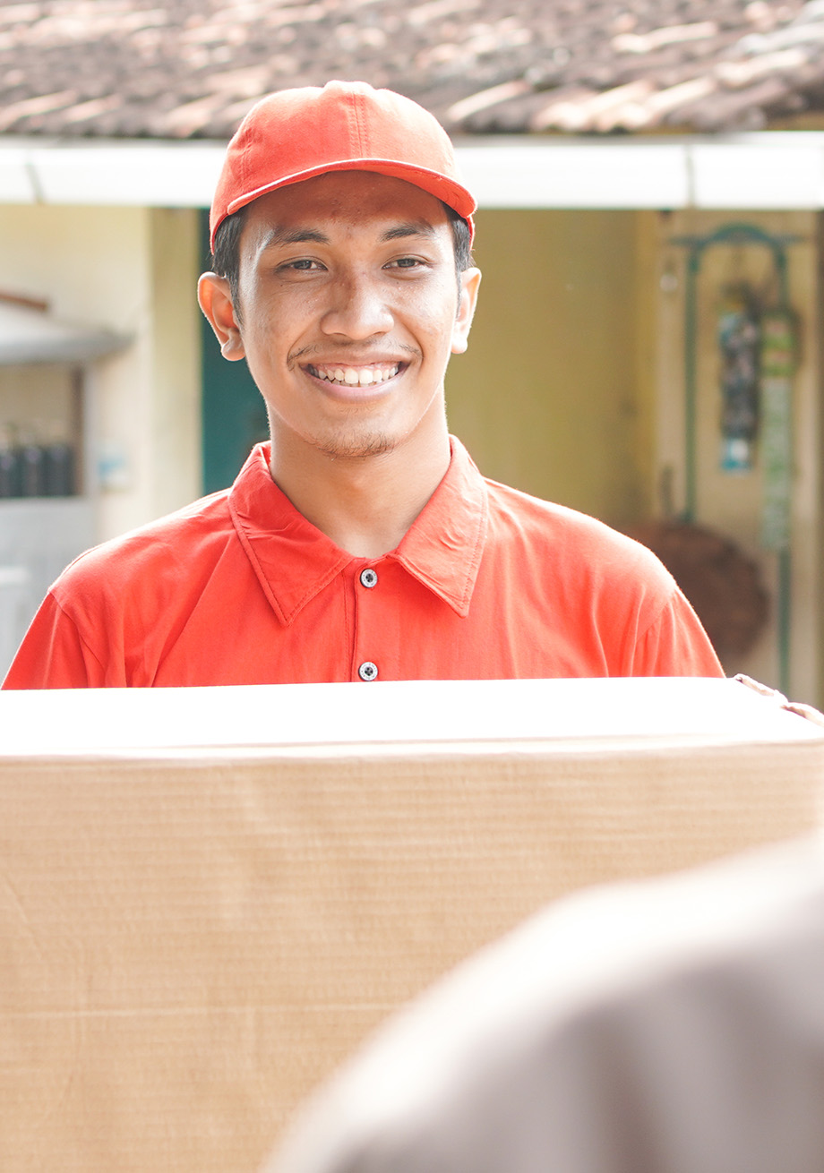 Delivery staff member holding a balikbayan box