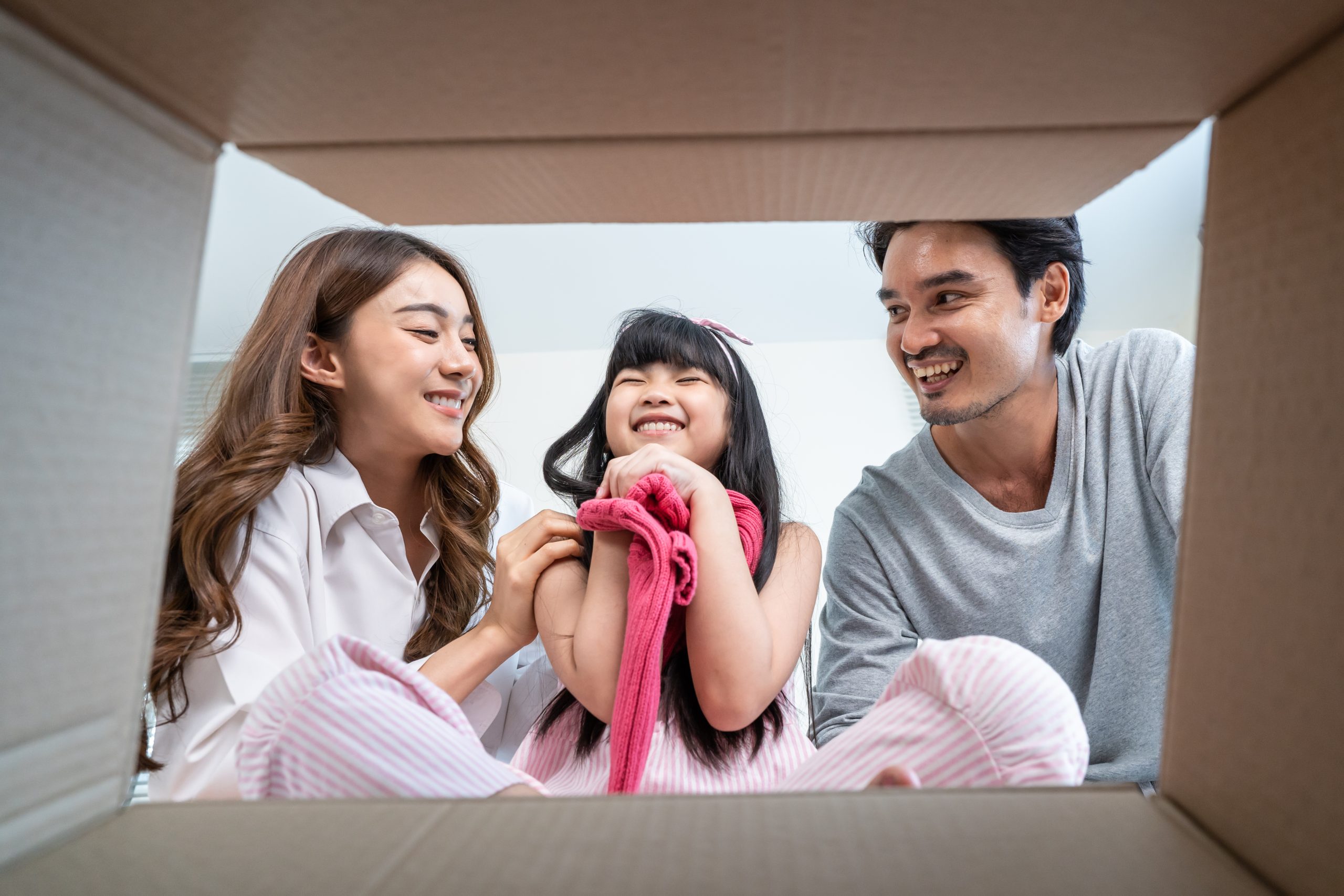 A family opening their balikbayan box